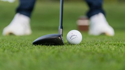 PGA pro Ben Emerson setting up to hit a 3-wood at Infinitum Golf Resort