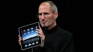 SAN FRANCISCO - JANUARY 27: Apple Inc. CEO Steve Jobs holds up the new iPad as he speaks during an Apple Special Event at Yerba Buena Center for the Arts January 27, 2010 in San Francisco, California. Apple introduced its latest creation, the iPad, a mobile tablet browsing device that is a cross between the iPhone and a MacBook laptop.