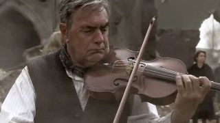 A man plays a violin in Band of Brothers