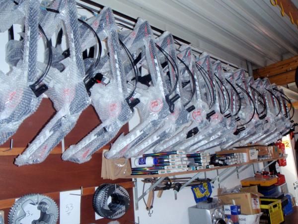 A row of spare time trial frames stay out of the way and protected