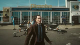 Tom Hiddleston looks to be in pain as he appears in front of a sports store in Loki.