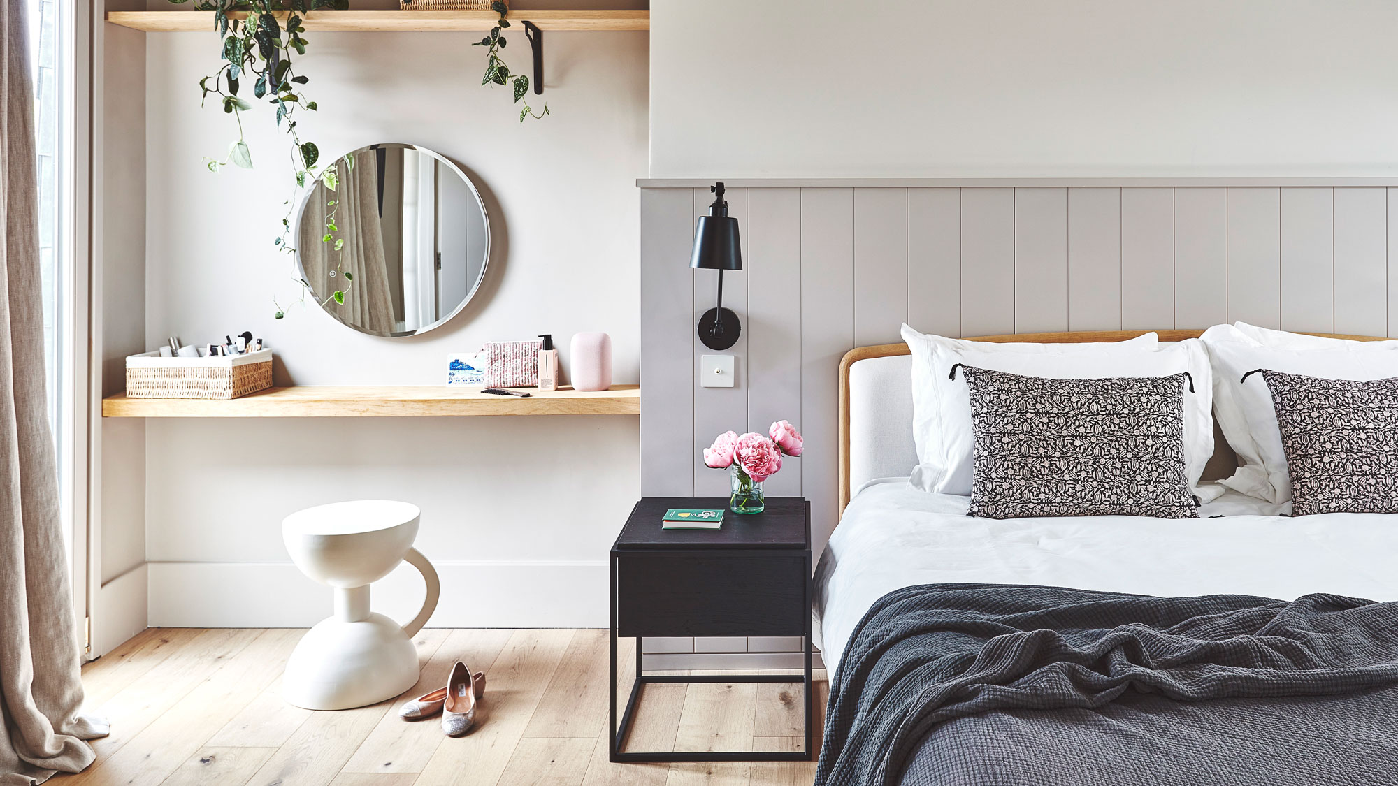 master bedroom with wooden flooring and grey half wall panelling