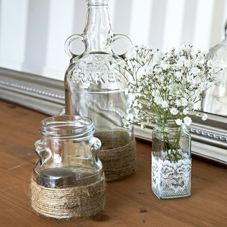 glass vase with white flower and wooden flooring