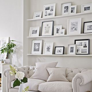 white wall and white sofa and shelve and picture frame