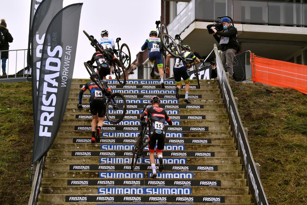 HOOGERHEIDE NETHERLANDS JANUARY 23 A general view of Lars Van Der Haar of Netherlands and Team Baloise Trek Lions Quinten Hermans of Belgium and Tormans Cyclo Cross Team Ryan Kamp of The Netherlands and Team Pauwels Sauzen Bingoal Toon Aerts of Belgium and Team Baloise Trek Lions Corne Van Kessel of The Netherlands and Tormans Cyclo Cross Team and Michael Vanthourenhout of Belgium and Team Pauwels Sauzen Bingoal compete climbing stairs on the circuit during the 32nd GP Adrie Van der Poel Hoogerheide UCI CycloCross Worldcup 2022 Mens Elite CXWorldCup on January 23 2022 in Hoogerheide Netherlands Photo by Luc ClaessenGetty Images