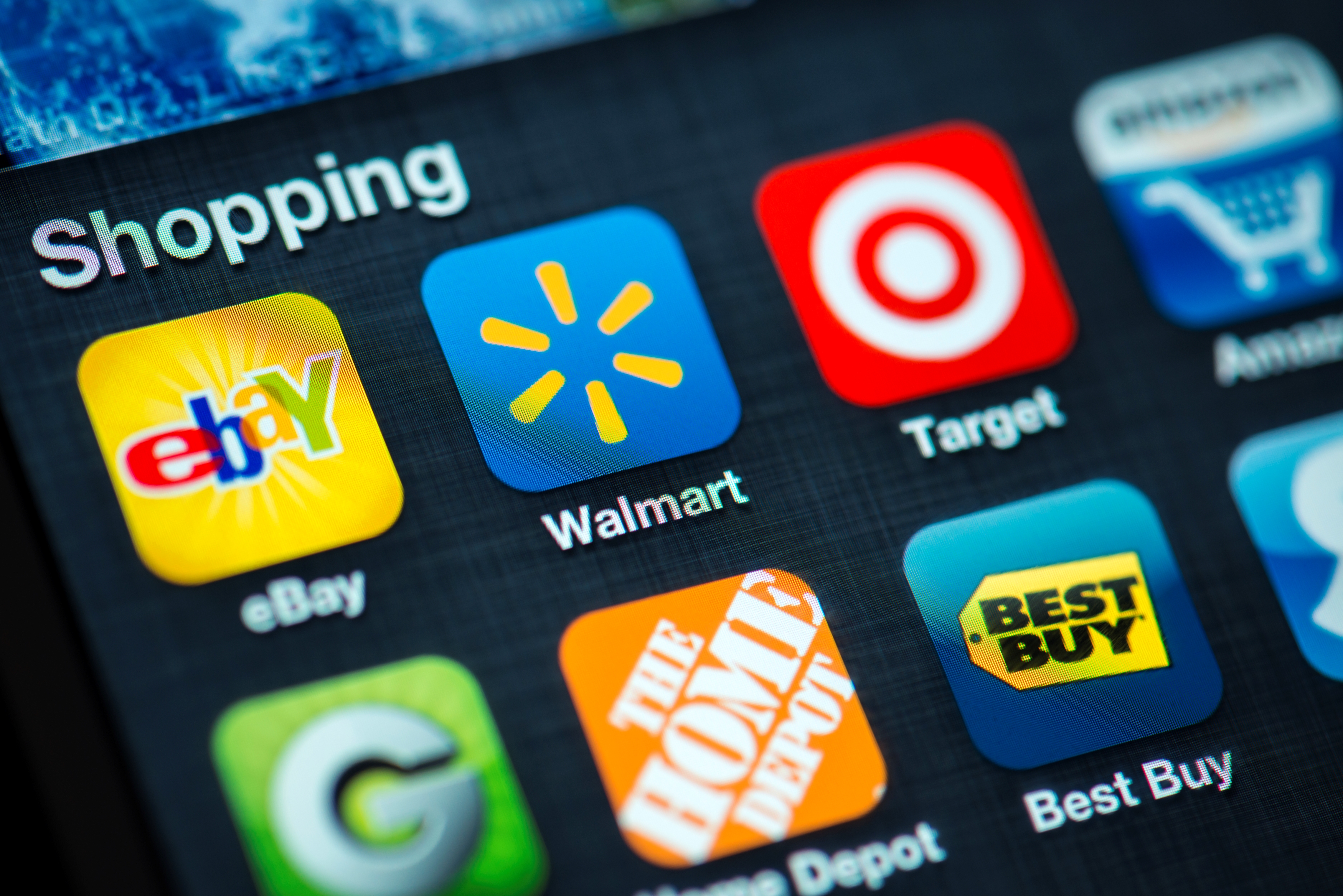 Walmart and Target app logos beside other shopping app logos on a phone screen.