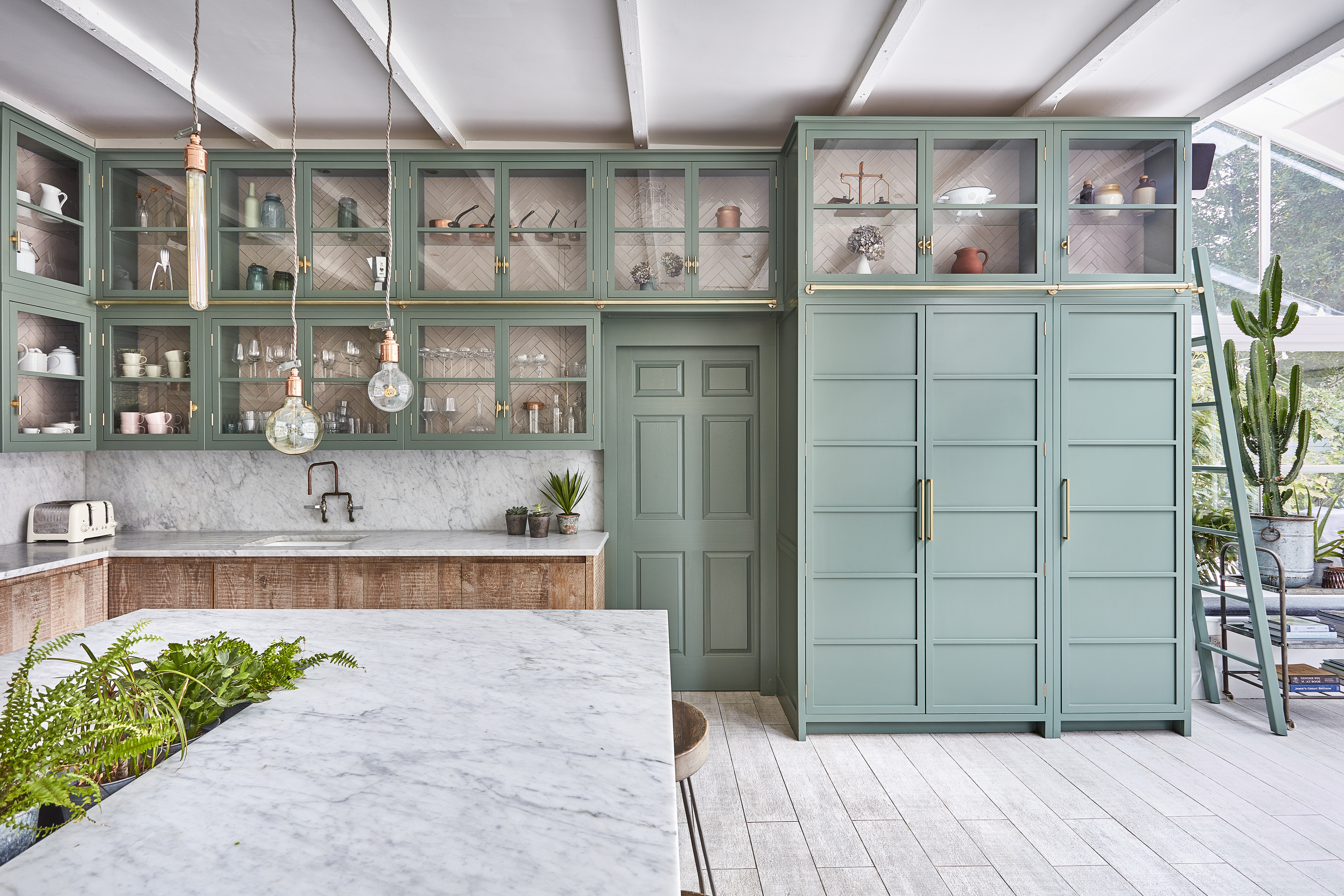 A kitchen with mint green kitchen cabinets