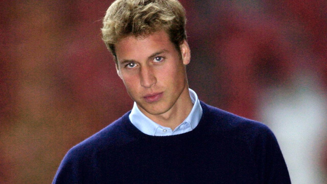 Prince William has big blond hair and piercing eyes, he wears a light blue shirt with a dark blue sweater over the top, on his first day at St Andrews University in Scotland