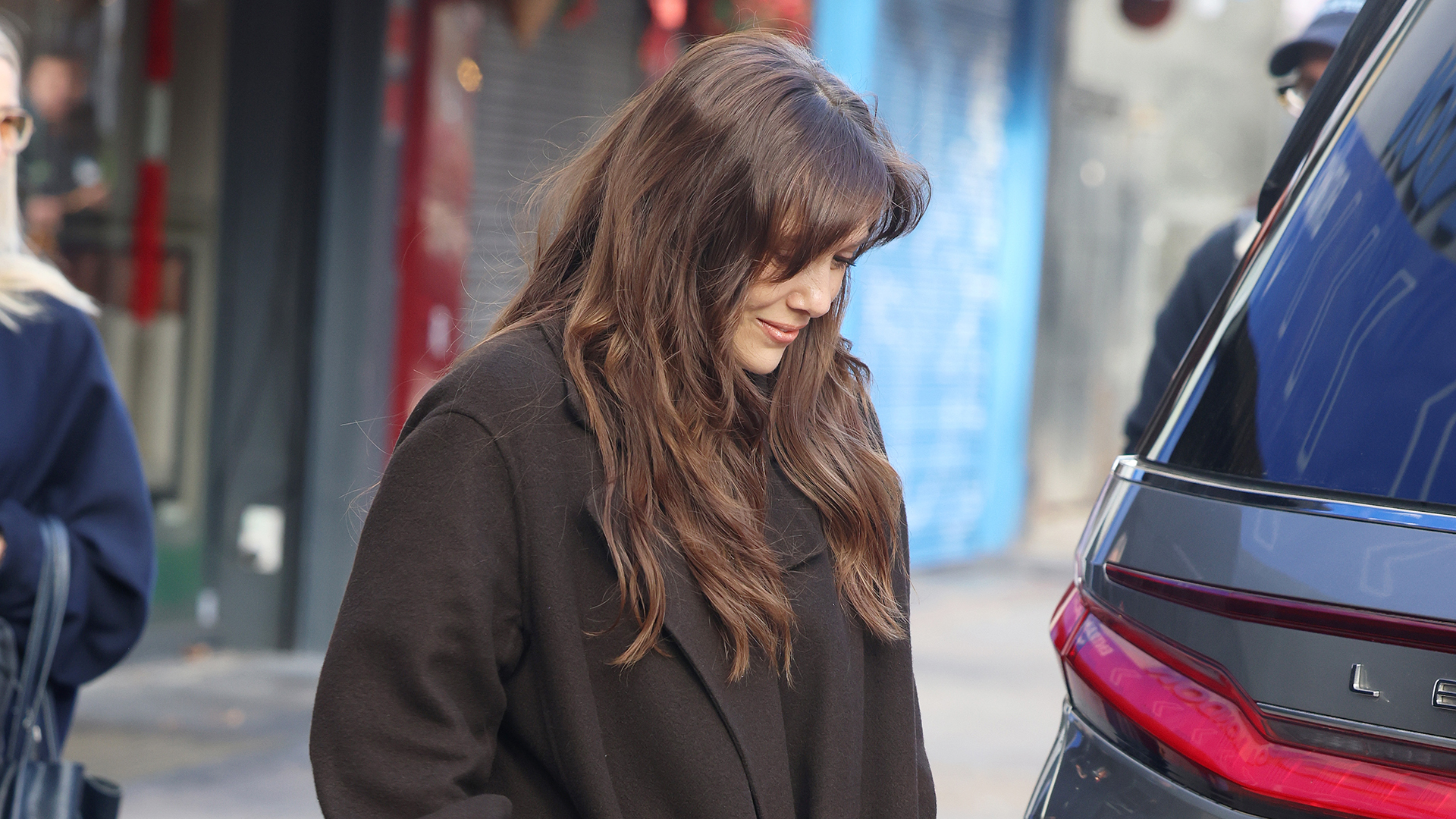 Elizabeth Olsen wearing an oversized brown wool coat