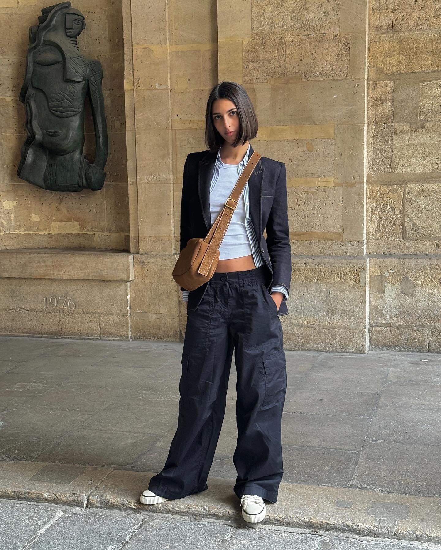 French fashion influencer Salome Mory wearing a chic fall outfit with black pants in Paris.