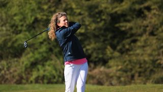 Golf Monthly Top 50 Coach Katie Dawkins hitting a shot at Essendon Golf Club