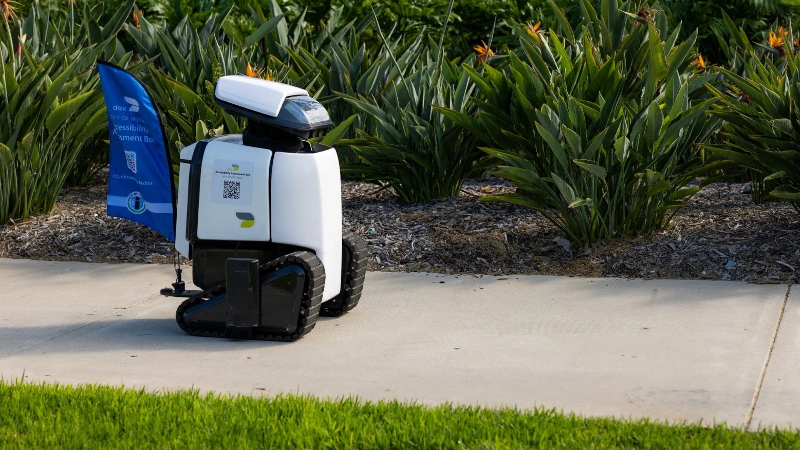 The Daxbot sits cutely on a sidewalk