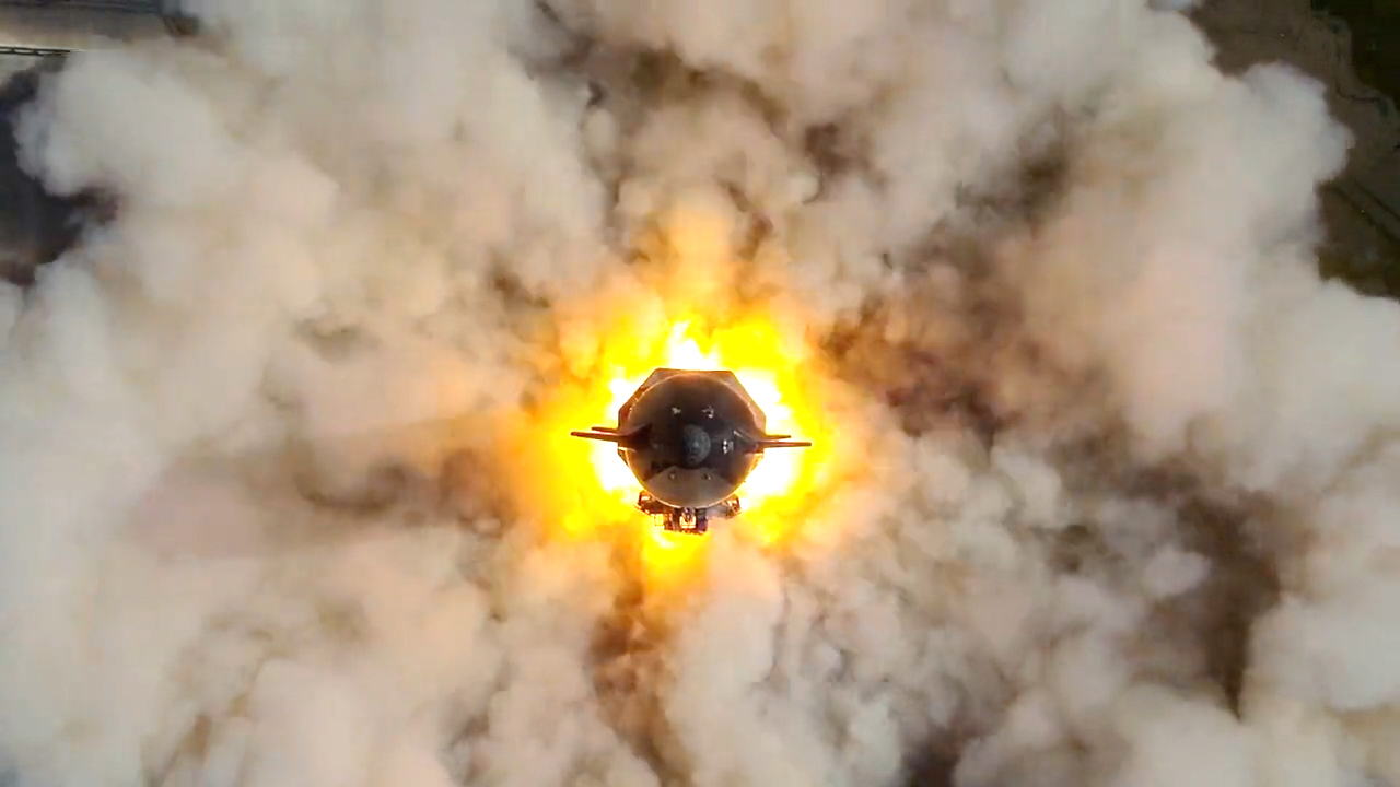 Top view of a spaceship surrounded by flames and smoke