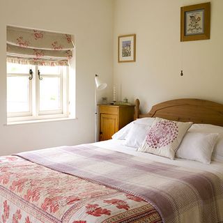 bedroom with white wall and double bed