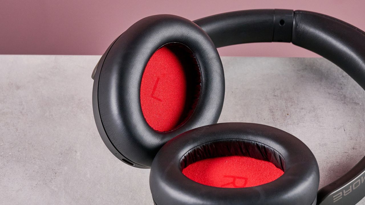 1More SonoFlow Pro HQ51 headphones on a gray surface with a pink background, showing the inside of the earcups