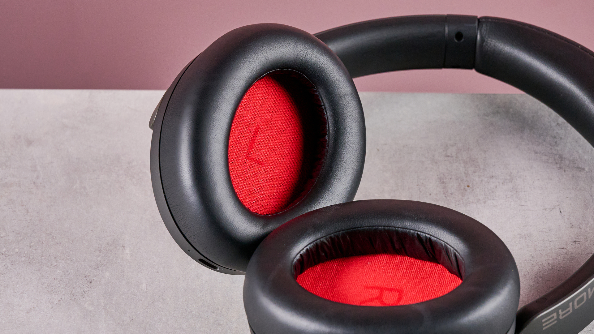 1More SonoFlow Pro HQ51 headphones on a gray surface with a pink background, showing the inside of the earcups