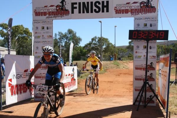 Naomi Hansen and Melissa Anset over the line at the Alice Springs BMX track