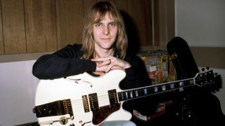 Alex LIFESON and RUSH, Alex Lifeson, posed, backstage, holding Gibson ES-355 guitar