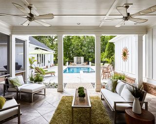 A house with a living room opening onto a backyard with pool