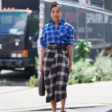 Tamu McPherson wearing the COS the blue checked flannel and brown checked skirt at fashion week. 