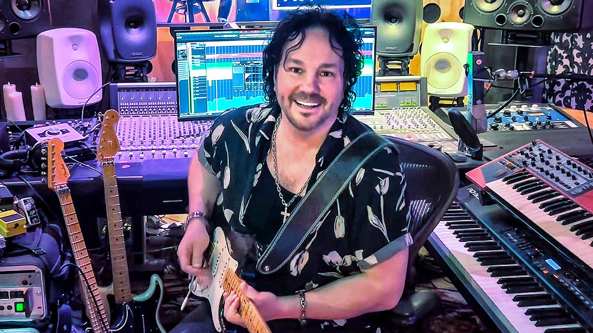 A photo Jimmy Westerlund in his home studio holding a Stratocaster electric guitar