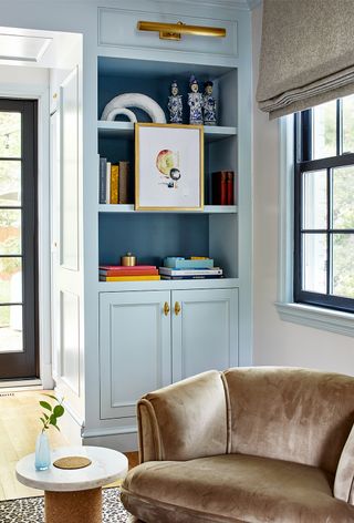 blue living room bookcase with art
