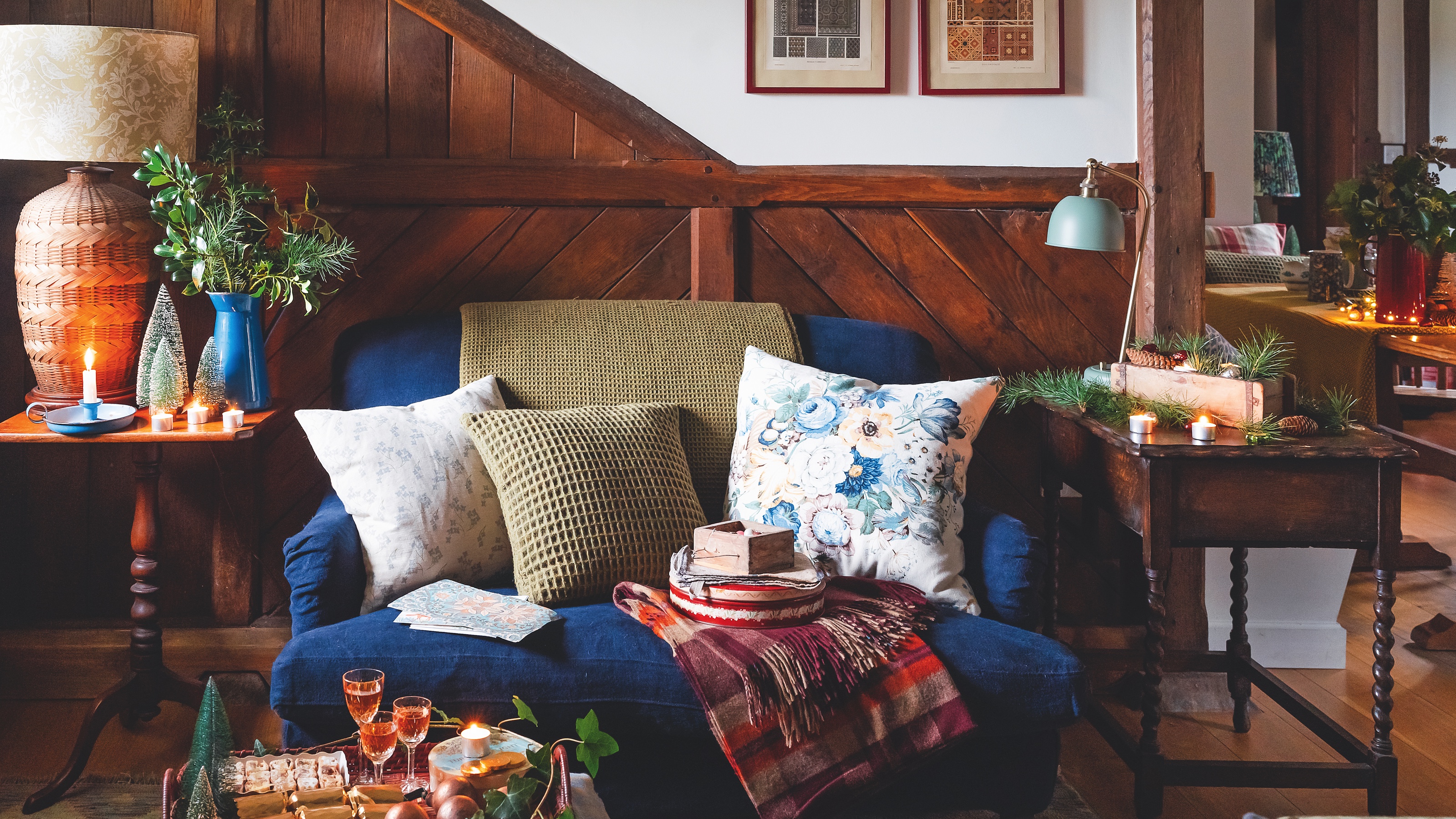 sitting room in coverted stables with wooden panel from stable stall and blue velvet sofa