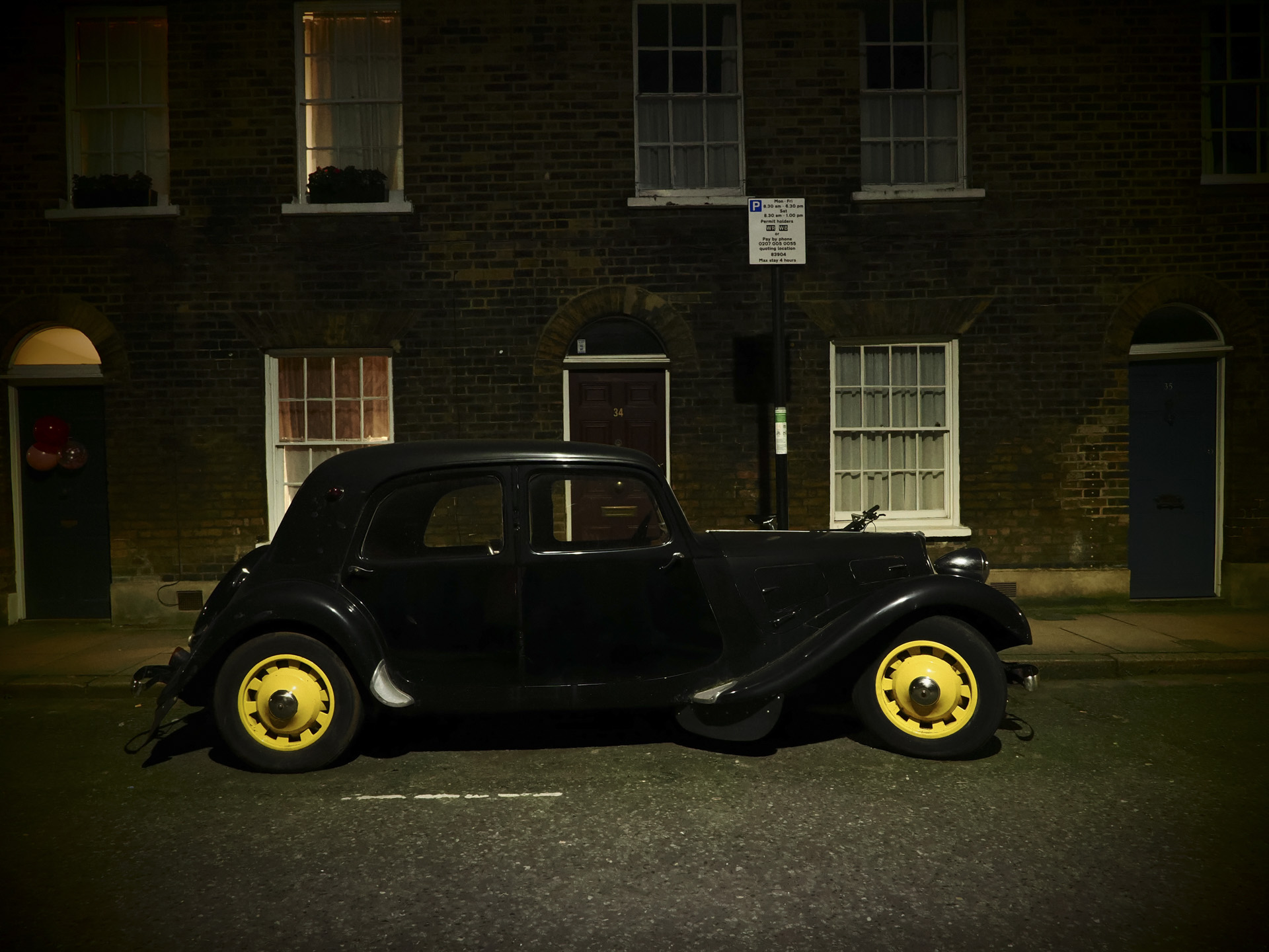 OM System OM-3 sample photos: classic car in quaint London street at night