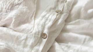 A close up of the buttons on a bedsheet