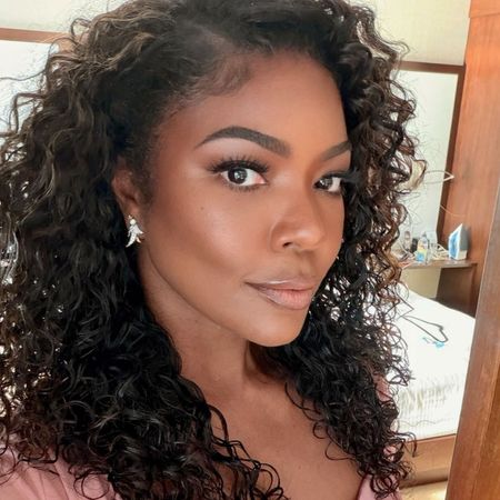 Gabrielle Union wears a long sleeved pink Zuhair Murad fall 2026 dress to Coco Jones's wedding. 