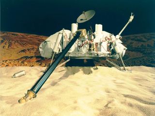 a four-legged, square-bodied mechanical device sits on a reddish-orange dusty planet