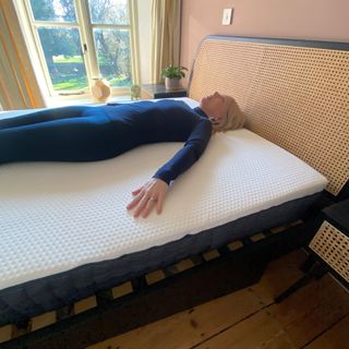 The Emma Hybrid Original mattress being tested by a female reviewer