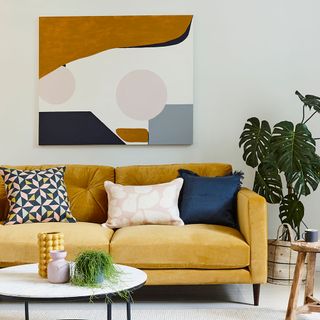 room with white wall and yellow sofa