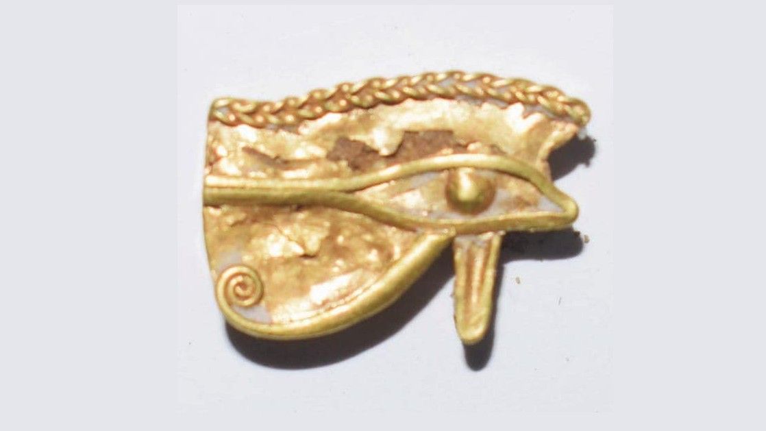 An Udjat eye made out of gold. Udjat eyes were popular in ancient Egypt and were considered to be the eye of Horus. They were associated with protection and healing.