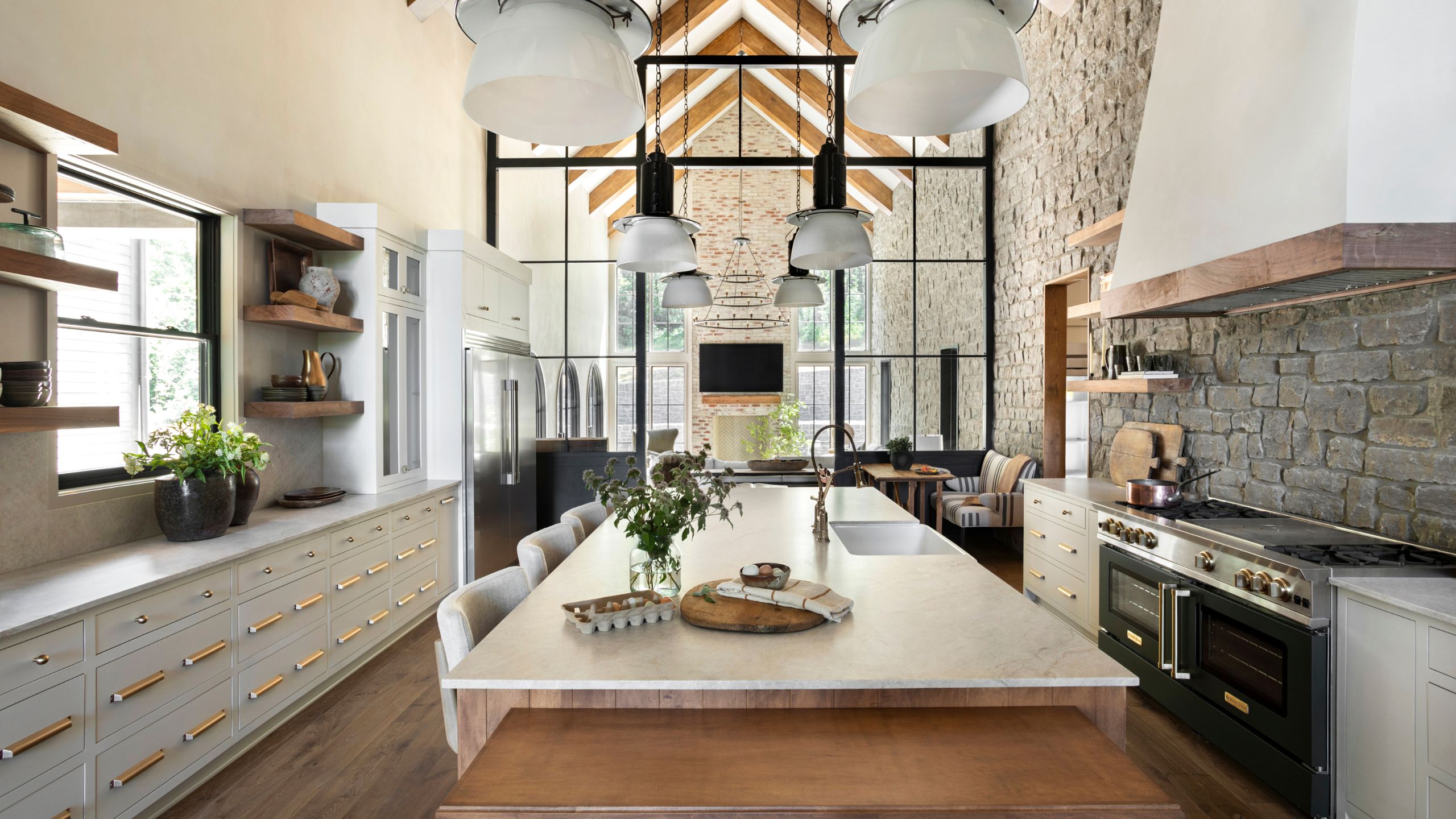 a new built kitchen in Tennessee with vaulted beamed ceiling, stone walls and grey cabinetry