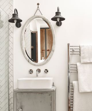White bathroom with mirror and wall lights