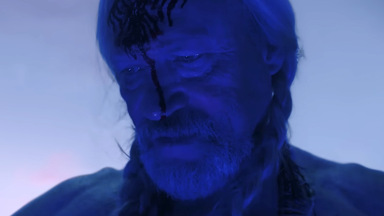 Red St. Wild in blue lighting with third eye on forehead in Peacemaker Season 2
