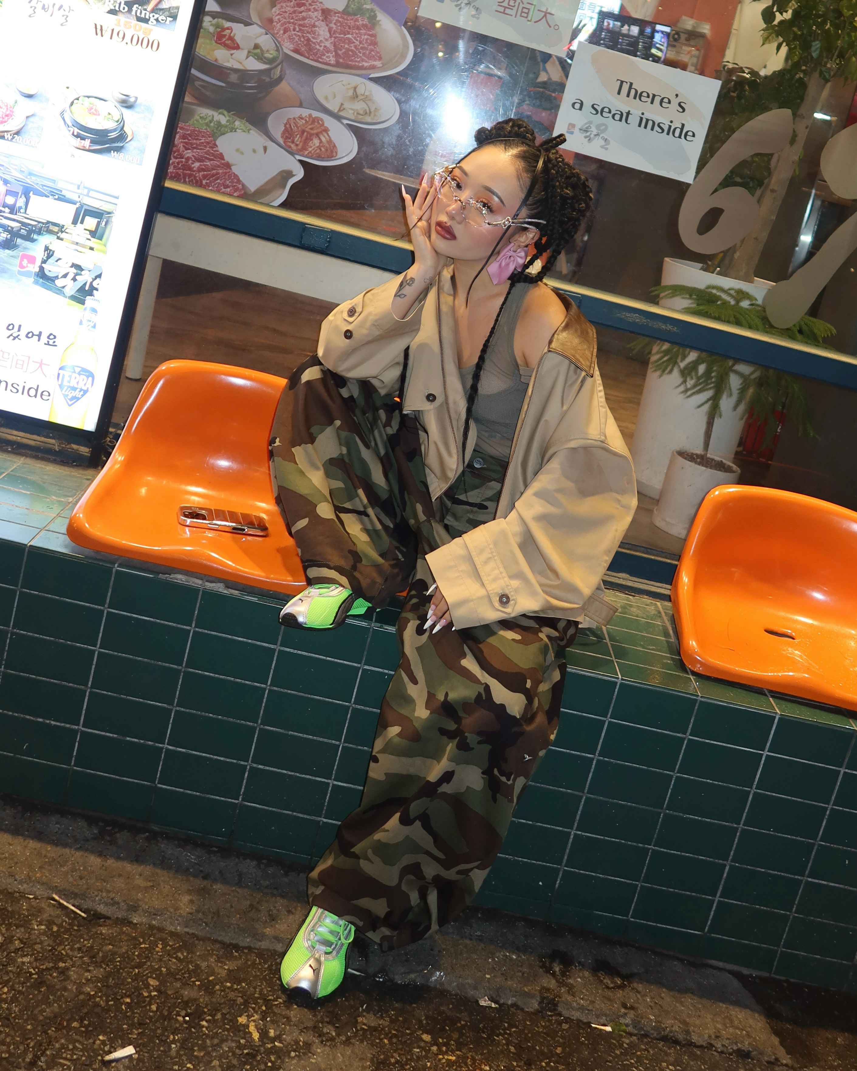 Jess Xu wearing camo pants and green Puma sneakers.