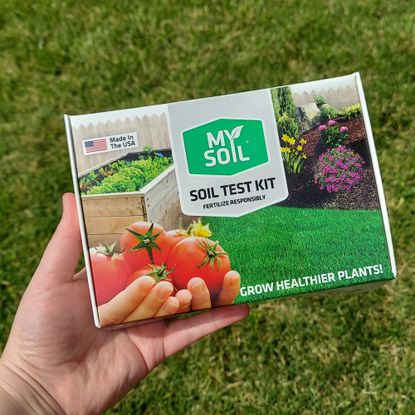 Gardener holding soil test kit box