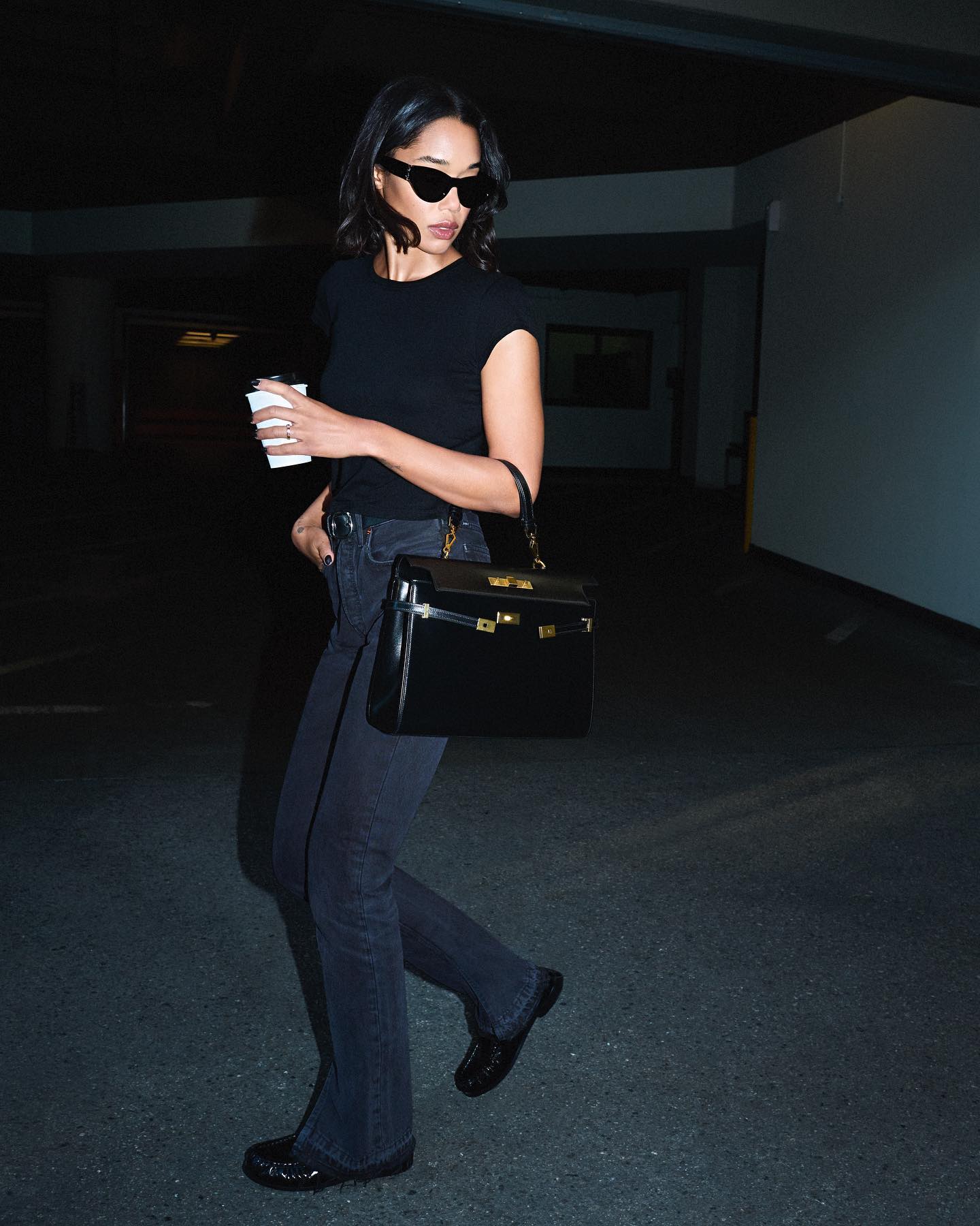 Laura Harrier wears jeans with loafers.