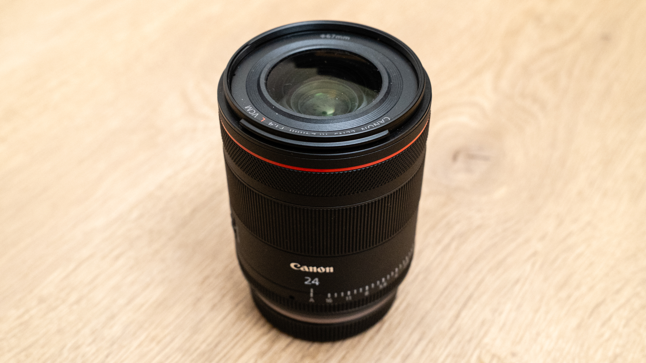 Canon RF 24mm f/1.4L VCM lens on a wooden floor