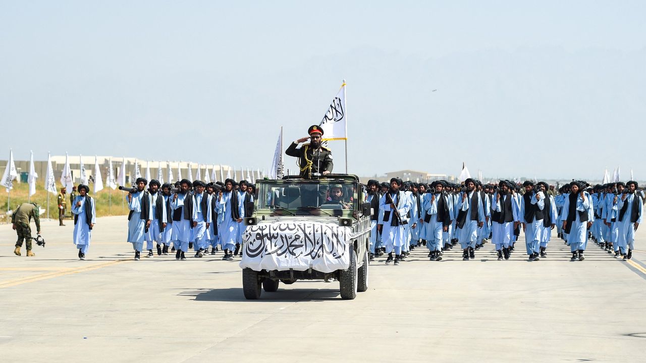 Taliban fighters take part in a military parade at Bagram air base to celebrate the third anniversary of the group&#039;s takeover of Afghanistan