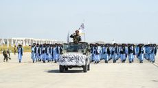 Taliban fighters take part in a military parade at Bagram air base to celebrate the third anniversary of the group's takeover of Afghanistan