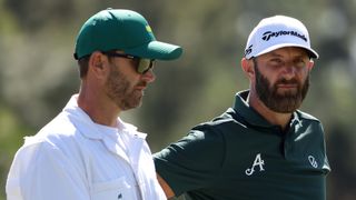 Dustin Johnson and his caddie in the second round of The Masters
