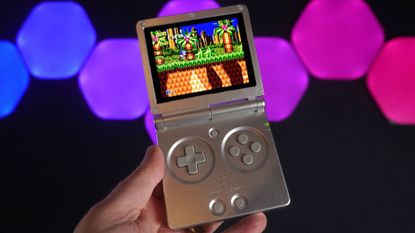 Anbernic RG35XXSP handheld with Sonic gameplay on screen and RGB lights in backdrop.