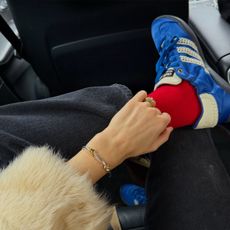 Woman in blue sneakers and red socks