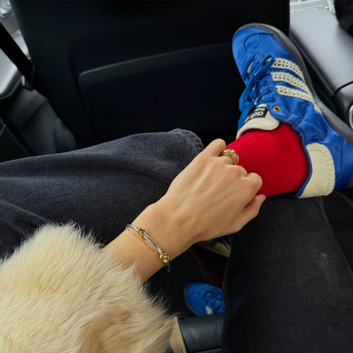 Woman in blue sneakers and red socks