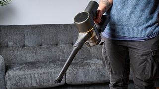 A black and gold Dreame R10 Pro cordless vacuum cleaner