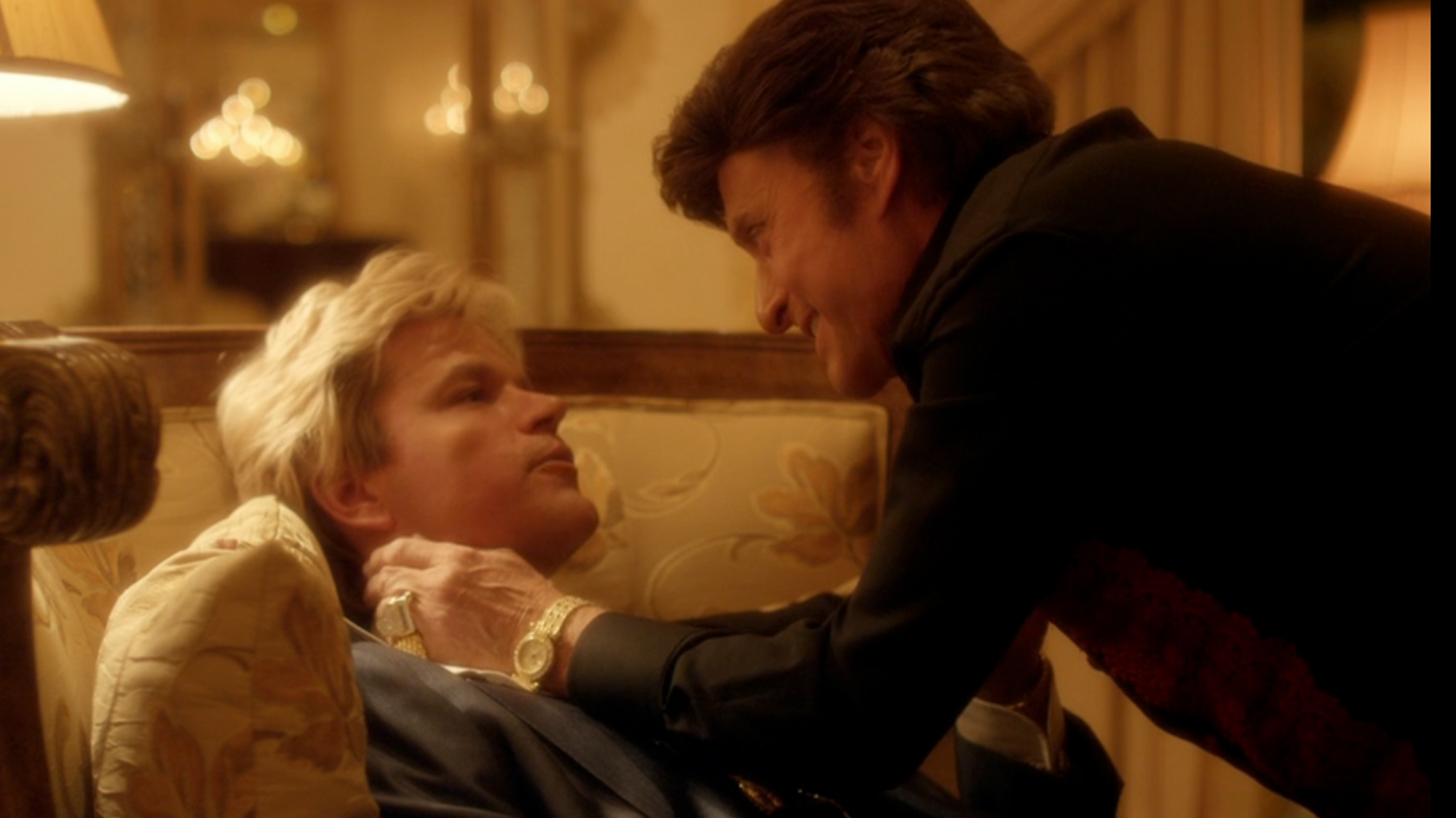 Michael Douglas standing over Matt Damon in Behind The Candelabra