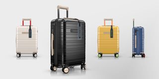 Circle One carry on luggage by Horizn Studios. Four hard shell cases on wheels with a handle in white, black, yellow and blue.